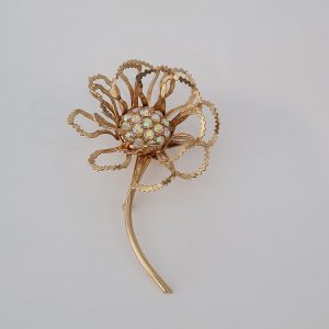 Sarah Coventry "Allusion" gold-tone flower brooch with an aurora borealis rhinestone center.