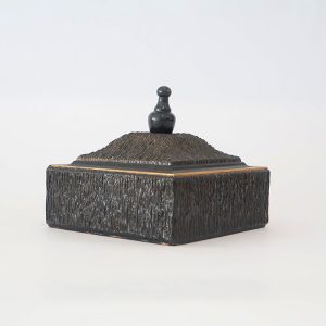 Vintage decorative box with a textured exterior and a lid